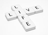 Scrabble game letters forming the words Life and Live as it is what it is all about at OneLife